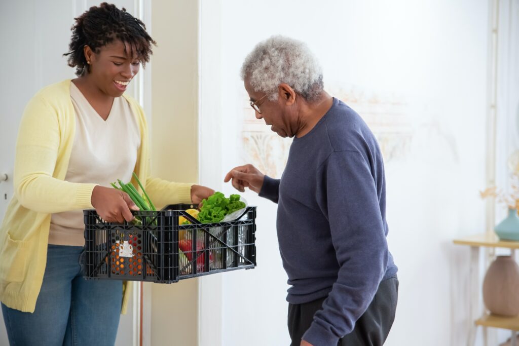 pexels-kampus-production-7551597 photo of woman helping elderly man with groceries